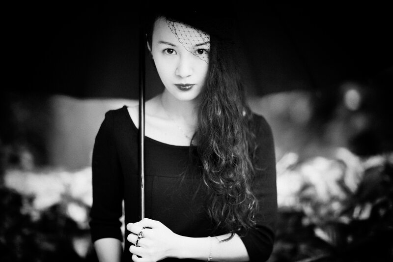 woman with veil holding umbrella