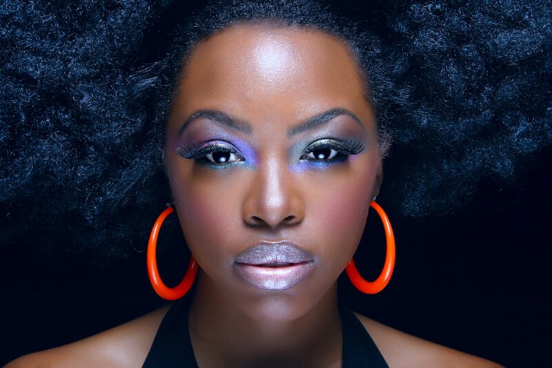 woman with vibrant makeup and afro