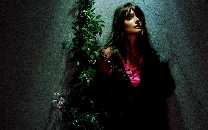woman with vines in dark room