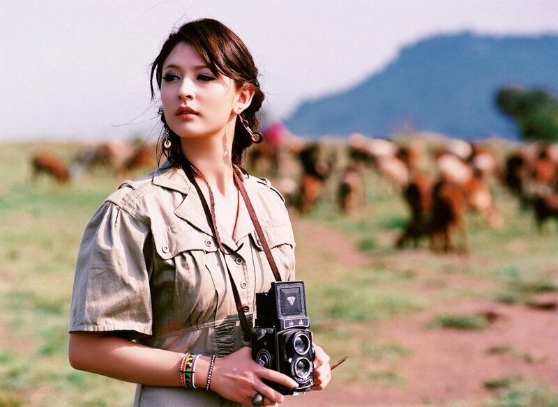 woman with vintage camera in field