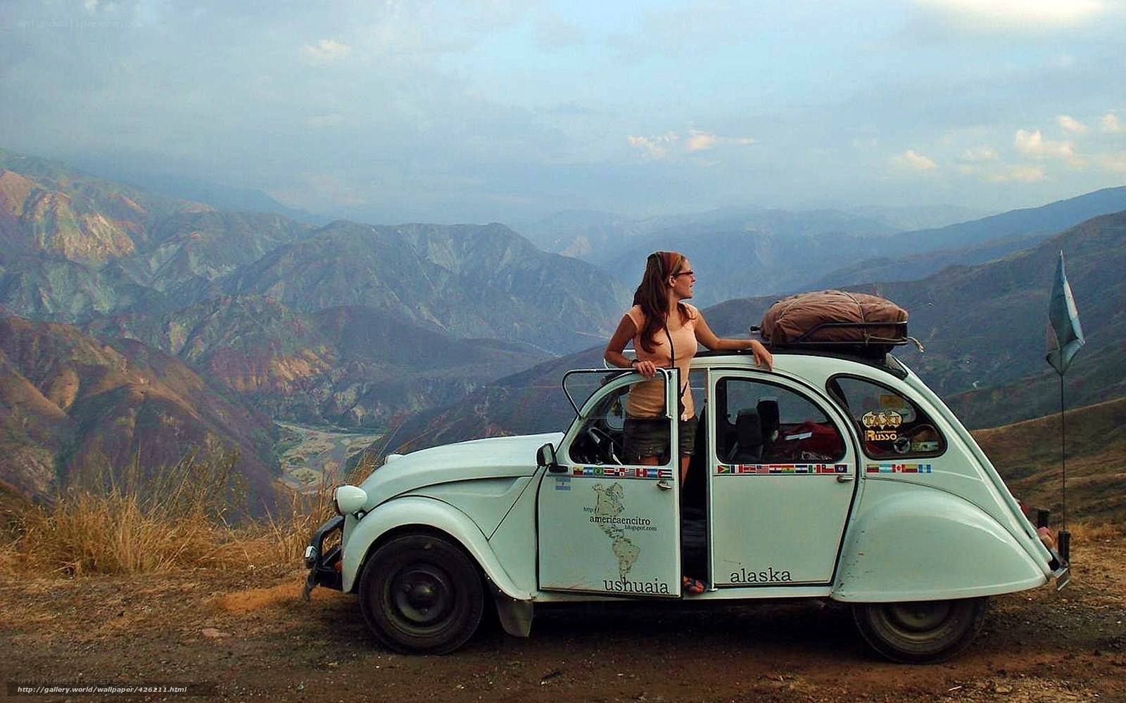 woman with vintage car in mountains
