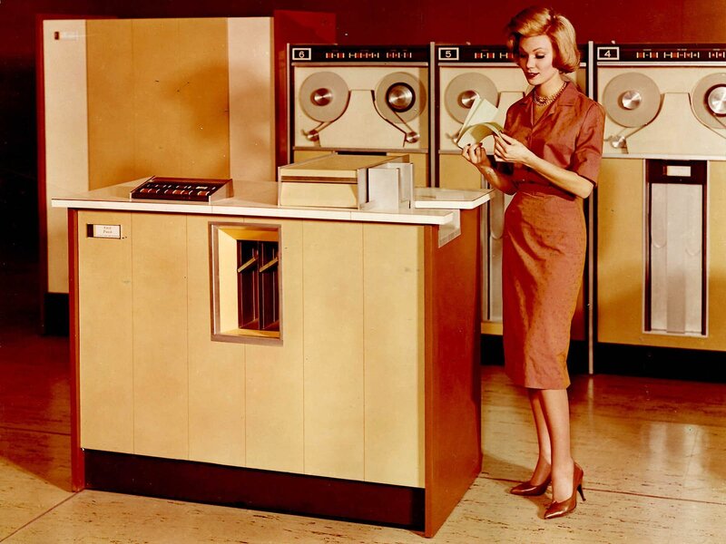 Woman with vintage computer equipment