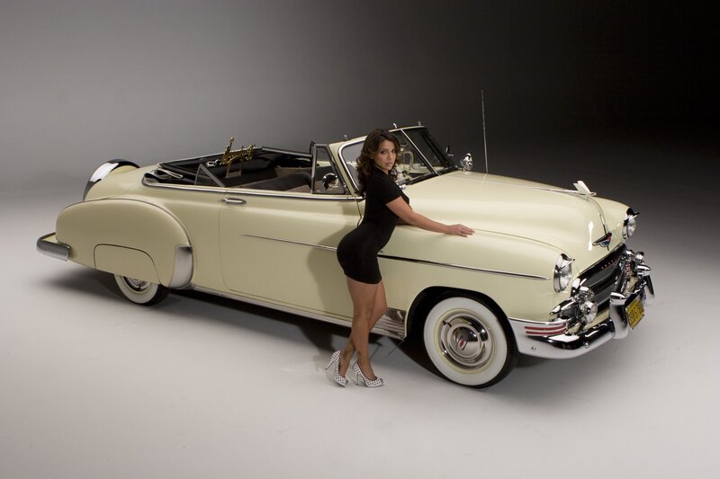 Woman with vintage convertible car