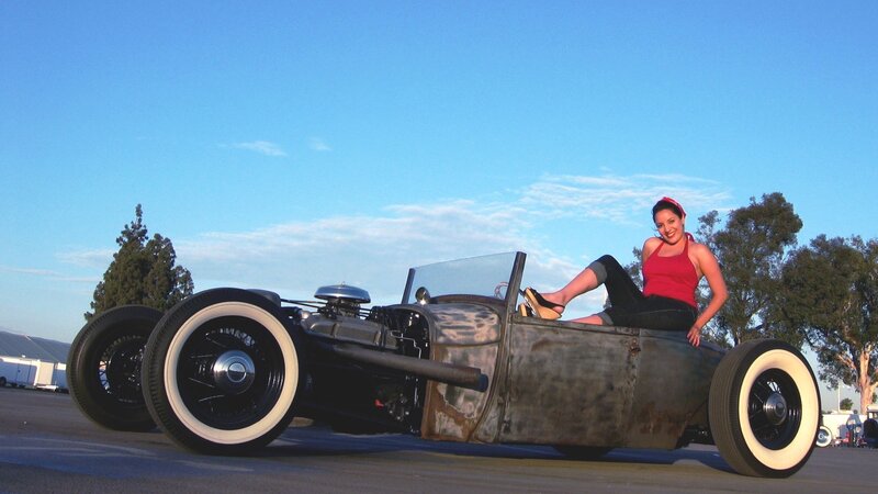 Woman with vintage hot rod car