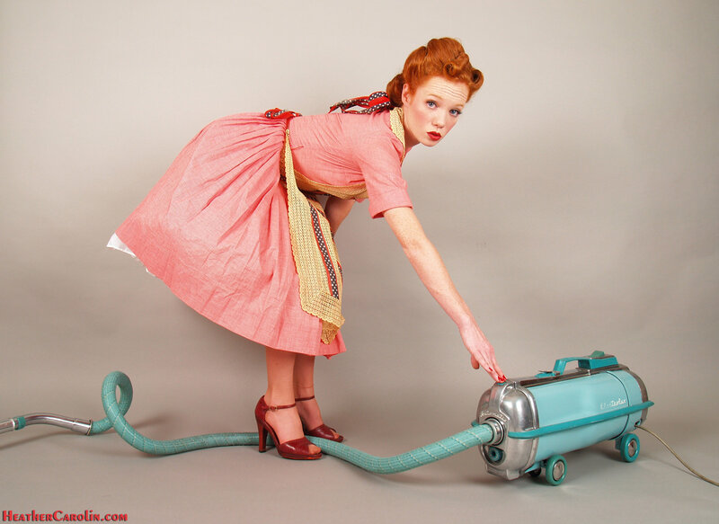 Woman with vintage vacuum cleaner