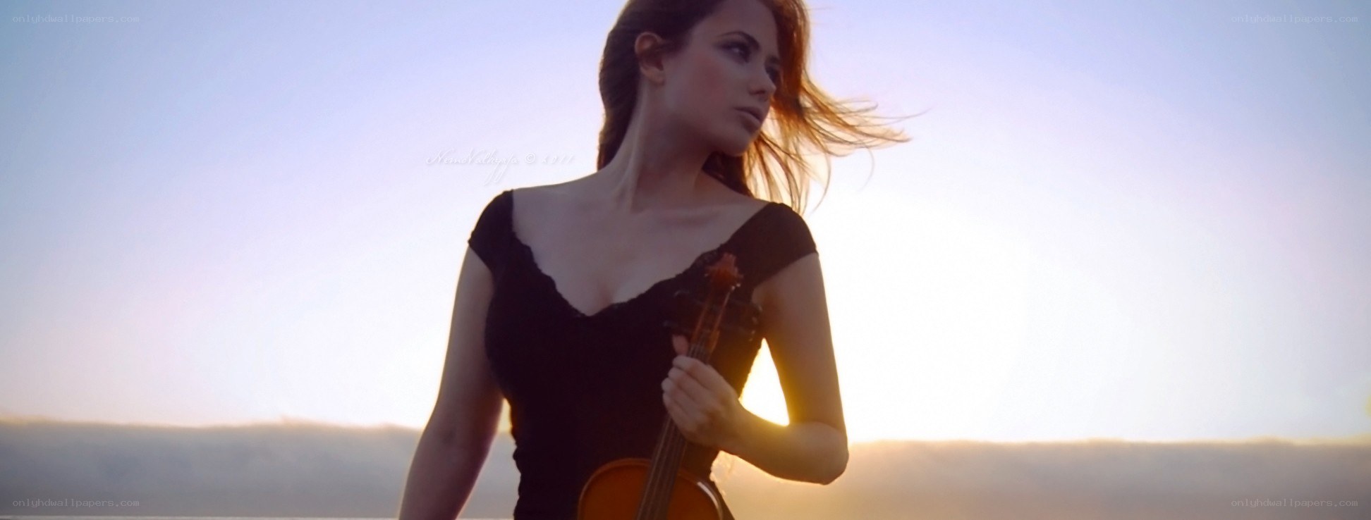 woman with violin at sunset