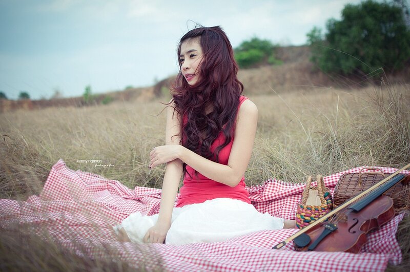 Woman with violin in a field