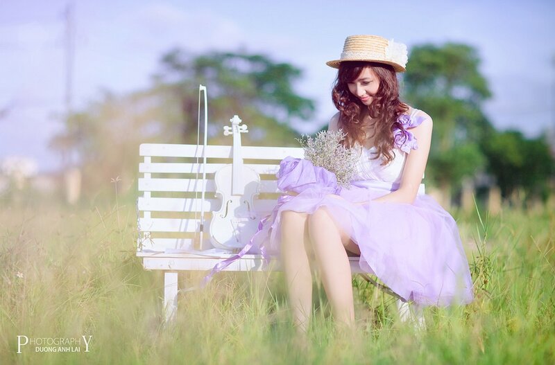 Woman with violin in field