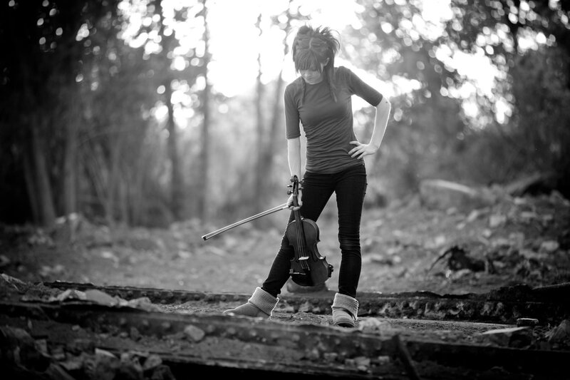 woman with violin in forest