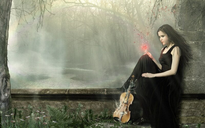 Woman with violin in misty forest
