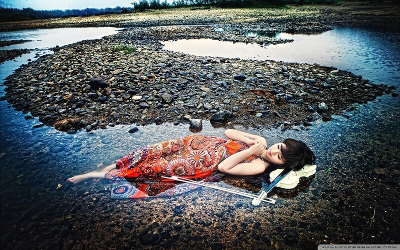 Woman with violin in river
