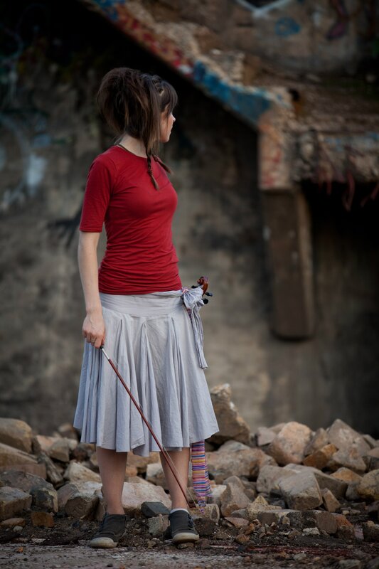 Woman with violin in ruins
