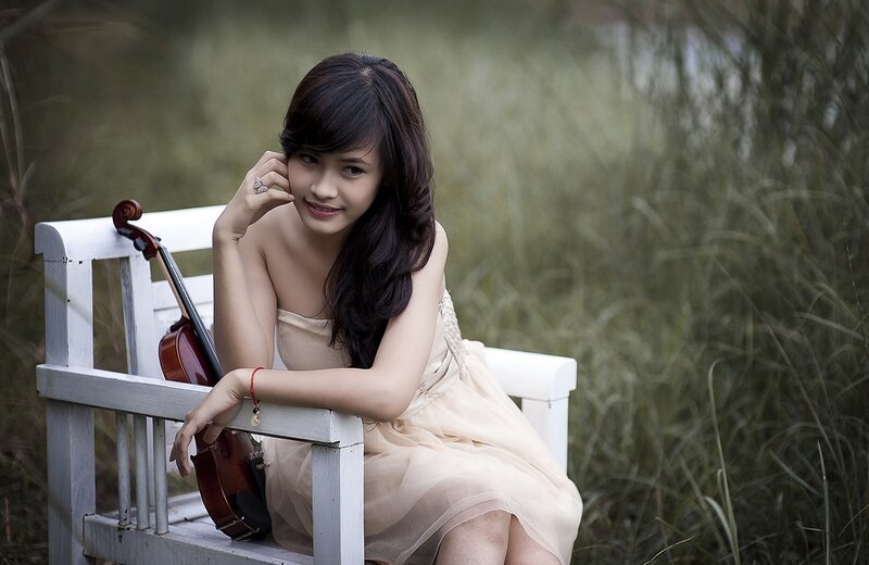 Woman with violin on bench