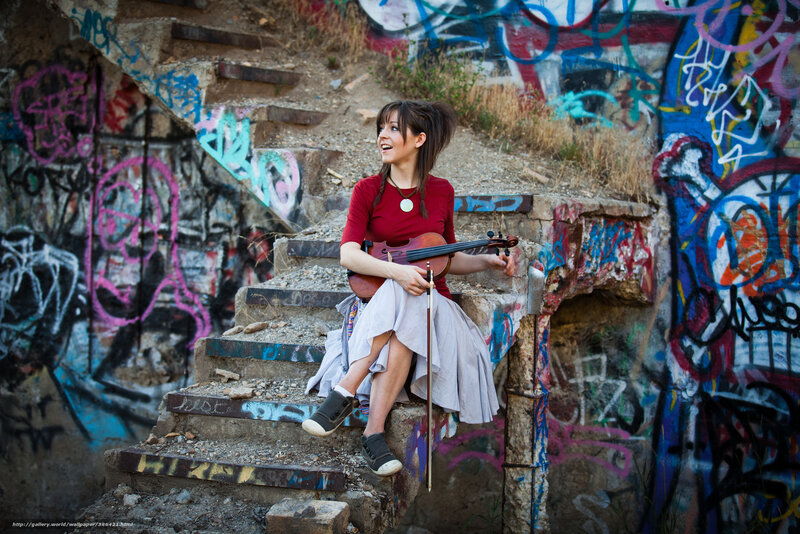 Woman with violin on graffiti stairs