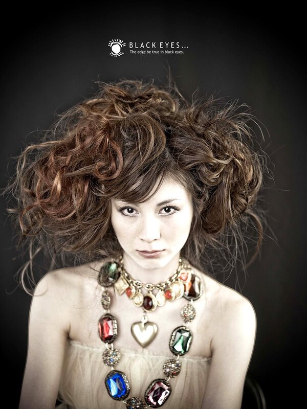 woman with voluminous hair and necklace