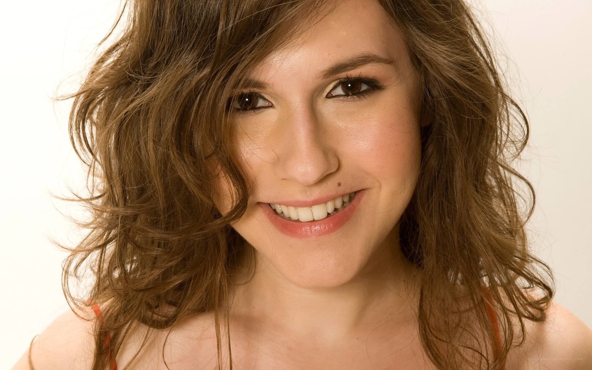 woman with wavy brown hair smiling
