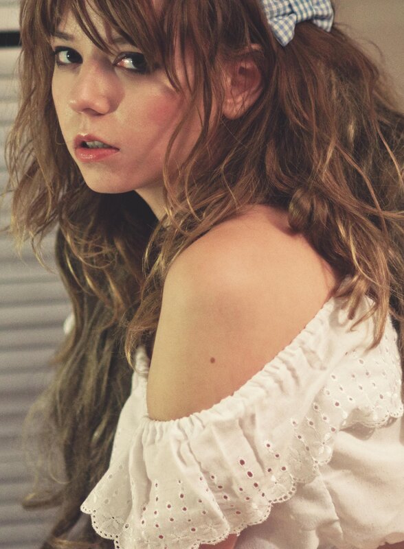 woman with wavy hair and bow