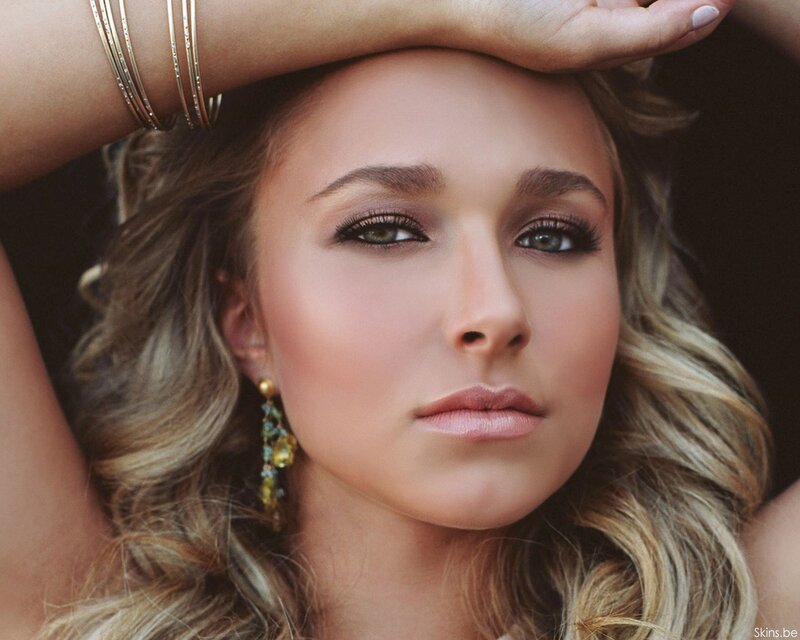 woman with wavy hair and earrings
