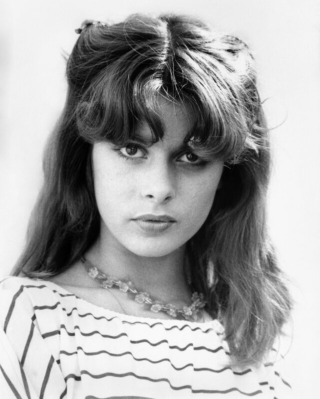woman with wavy hair and necklace