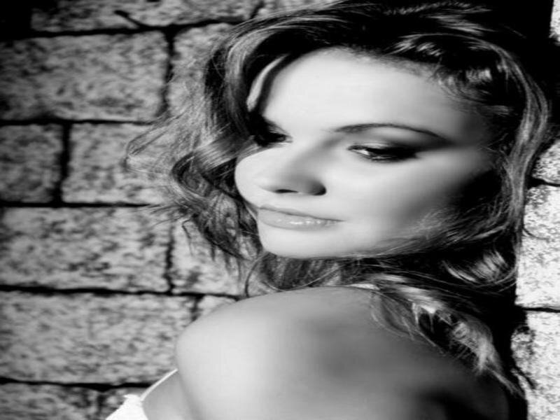 Woman with Wavy Hair — Black, Dramatic, Photograph, Brick Wall