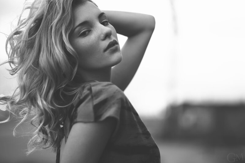 woman with wavy hair in black and white