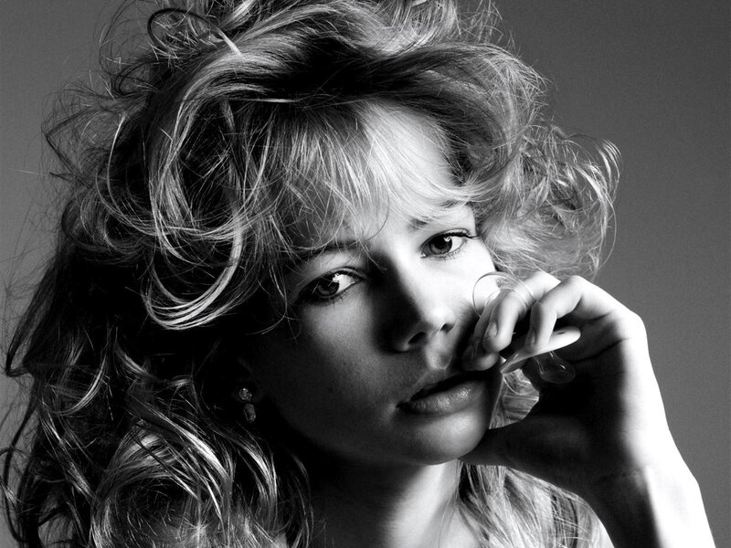 woman with wavy hair in black and white