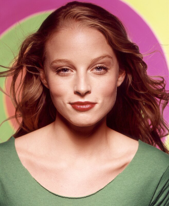 woman with wavy hair in green top