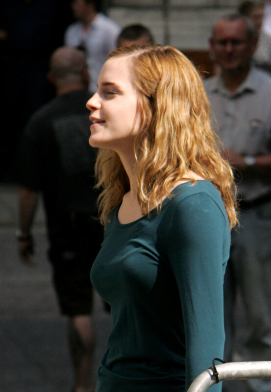 woman with wavy hair in green top