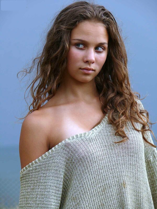 woman with wavy hair in sweater