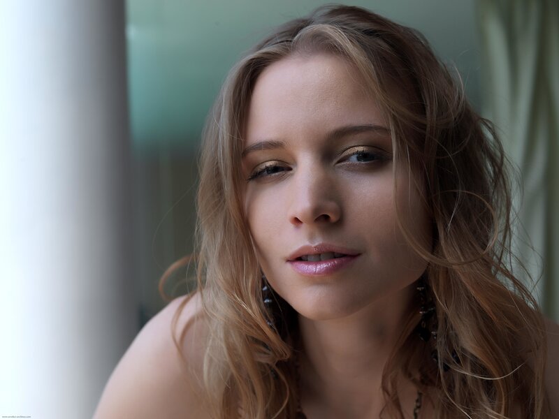 woman with wavy hair looking at camera