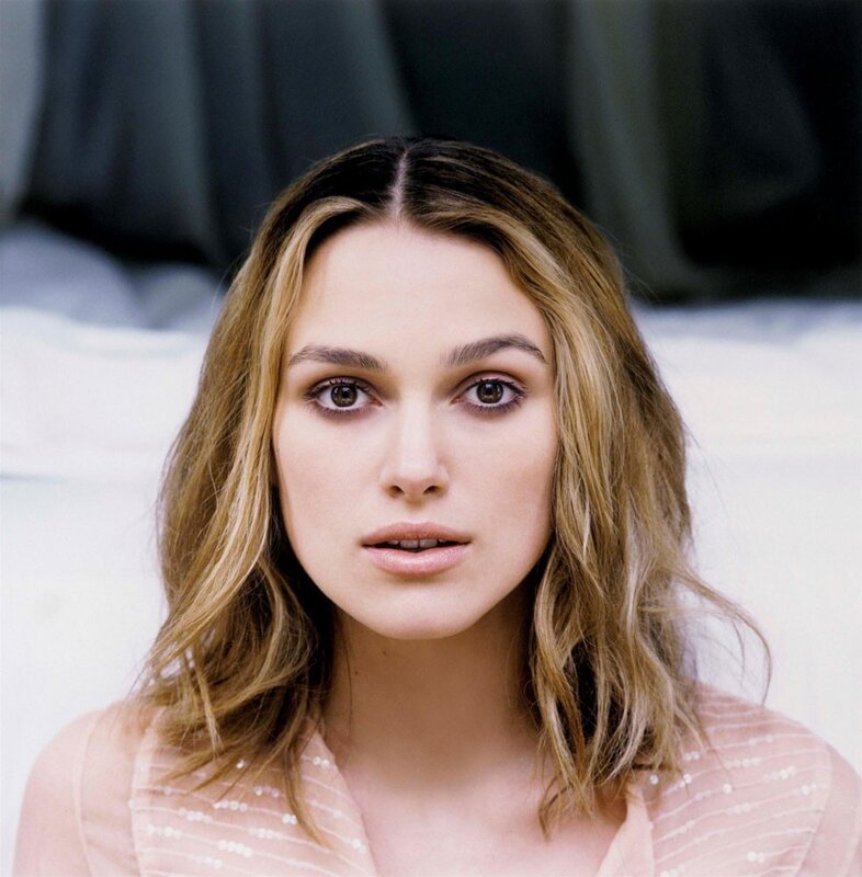 woman with wavy hair looking at camera