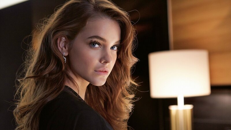 woman with wavy hair looking at camera