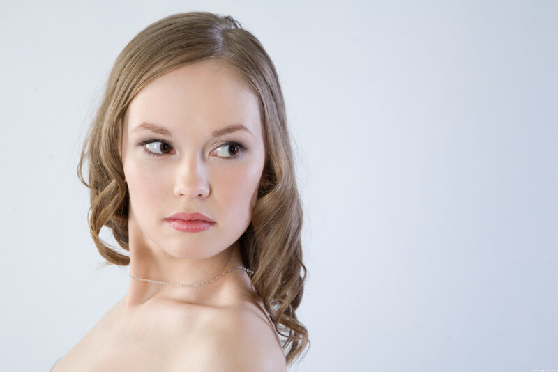 woman with wavy hair looking away