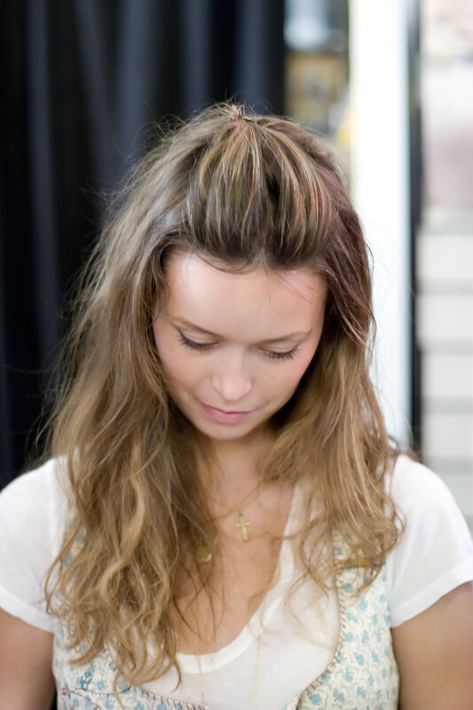 woman with wavy hair looking down