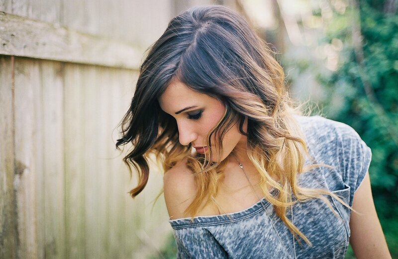 woman with wavy hair looking down