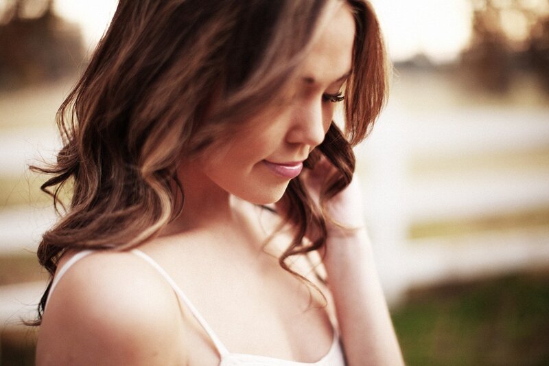 woman with wavy hair looking down