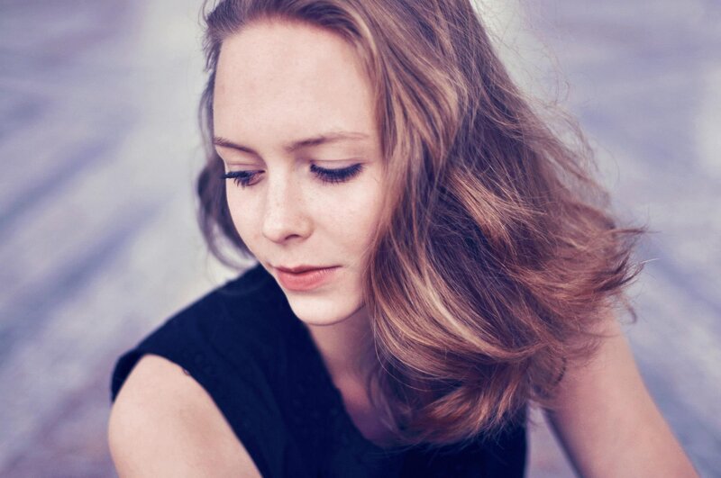 woman with wavy hair looking down