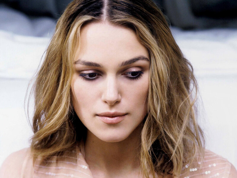 woman with wavy hair looking down