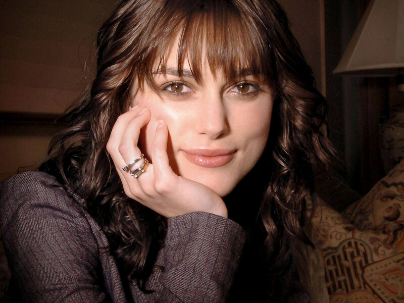 woman with wavy hair resting hand