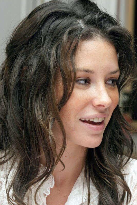 woman with wavy hair smiling