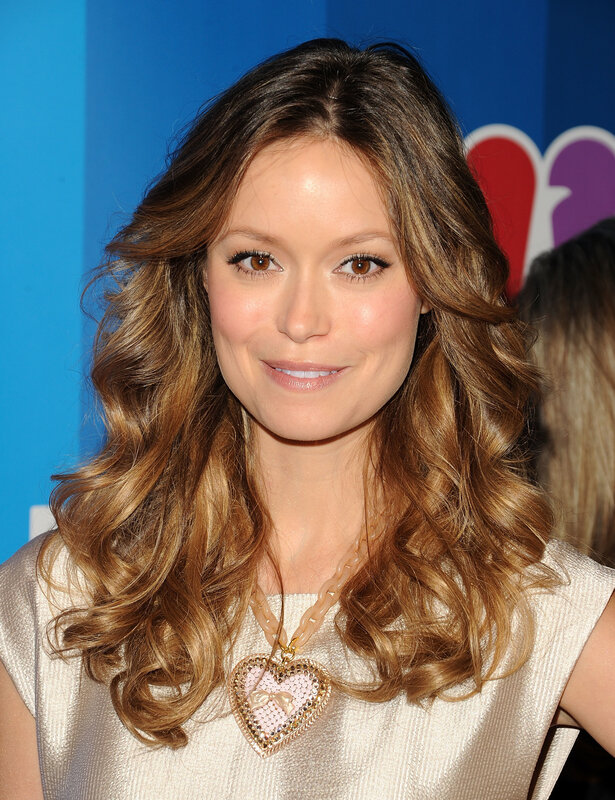 woman with wavy hair smiling
