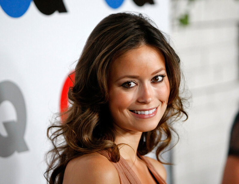 woman with wavy hair smiling