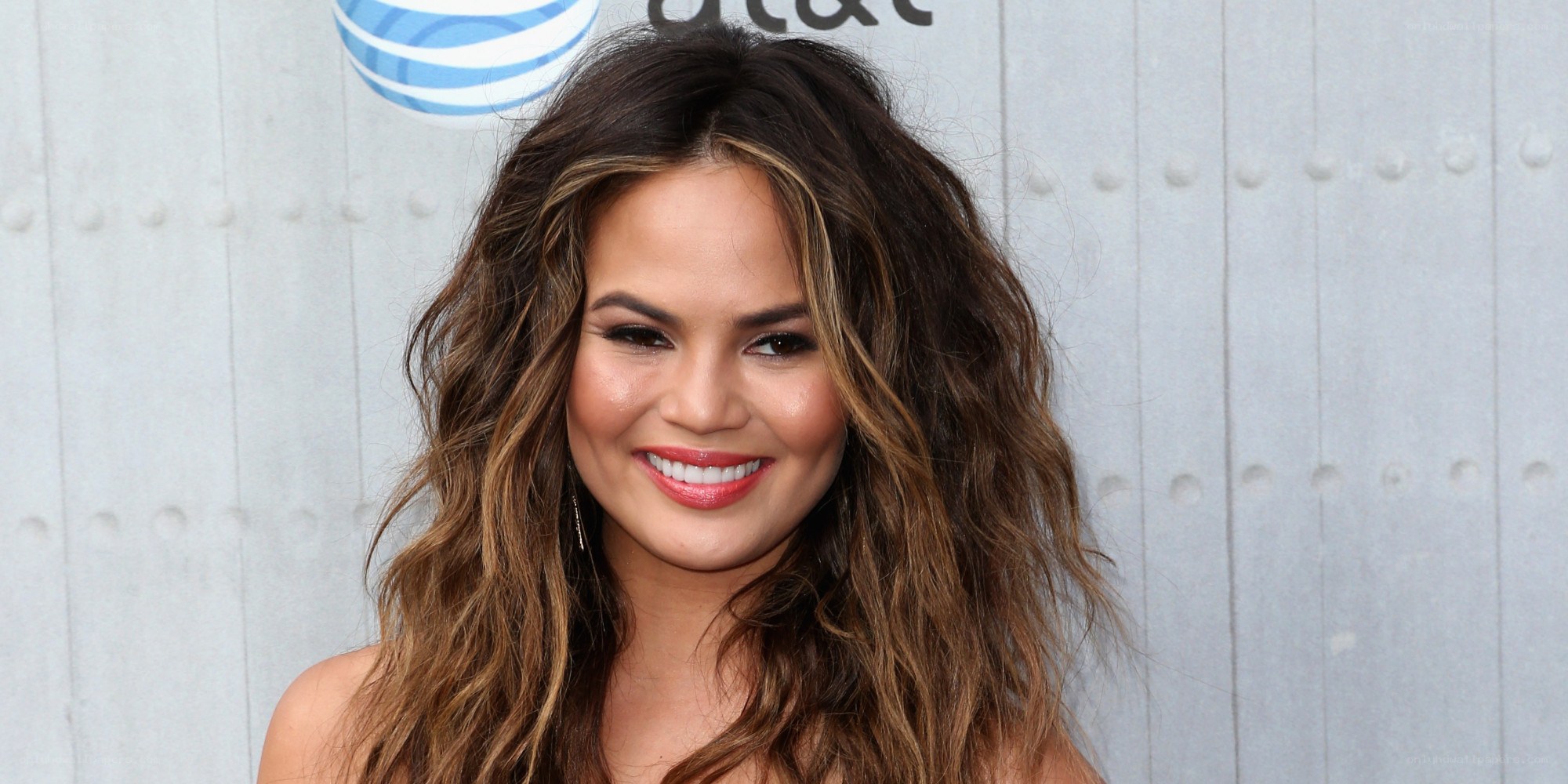 woman with wavy hair smiling