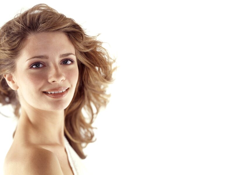 woman with wavy hair smiling