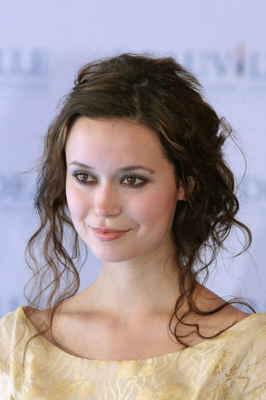 woman with wavy hair smiling