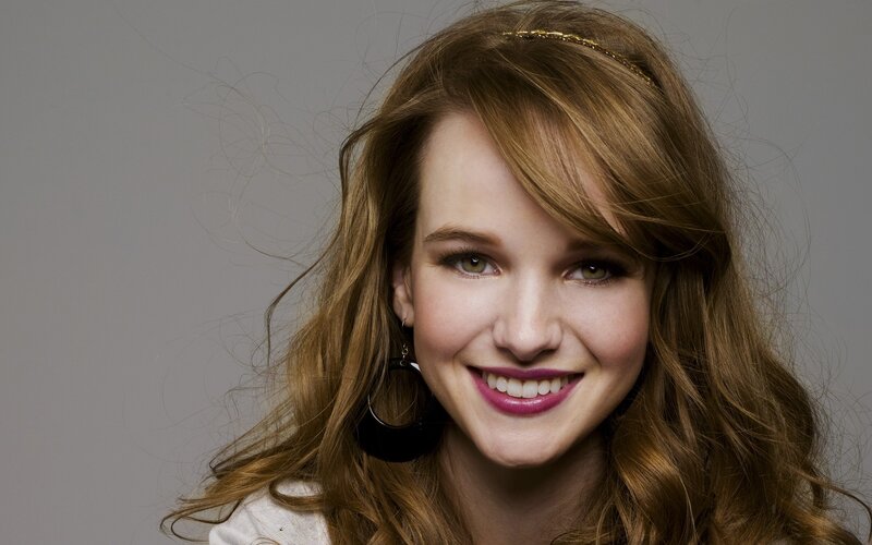 woman with wavy hair smiling