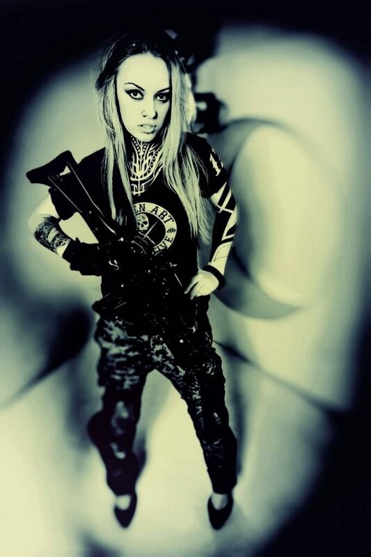 woman with weapon and tattoos