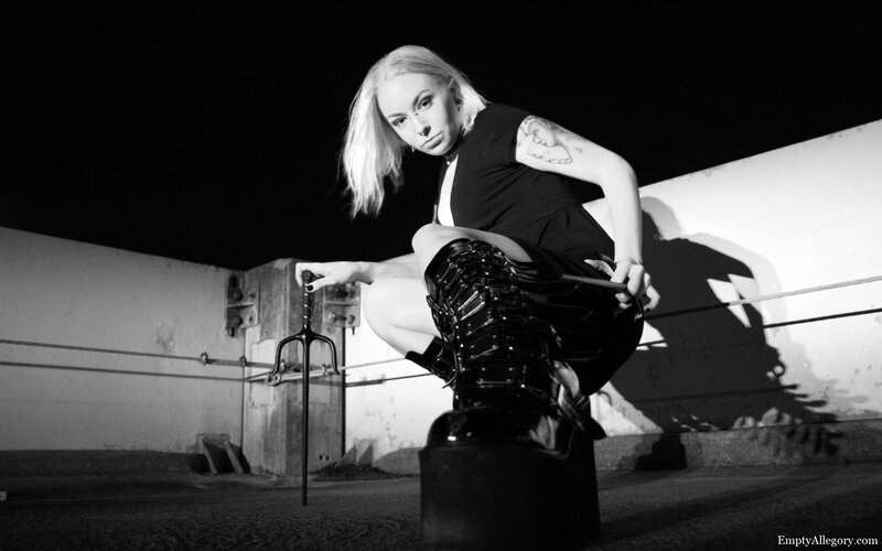 woman with weapon on rooftop