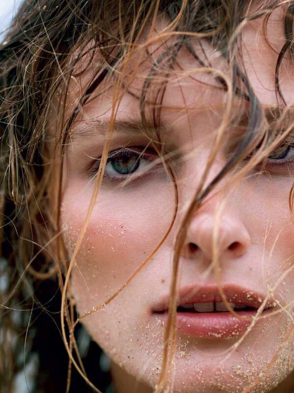 woman with wet hair and sand