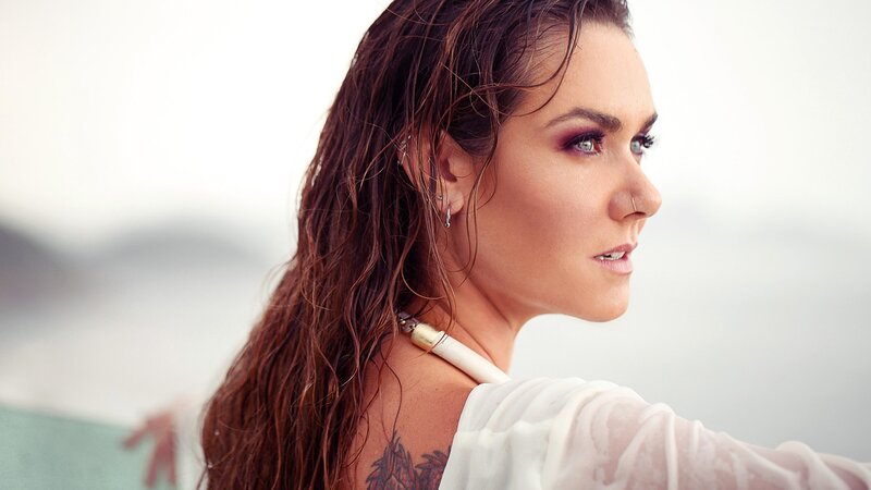 woman with wet hair and tattoo